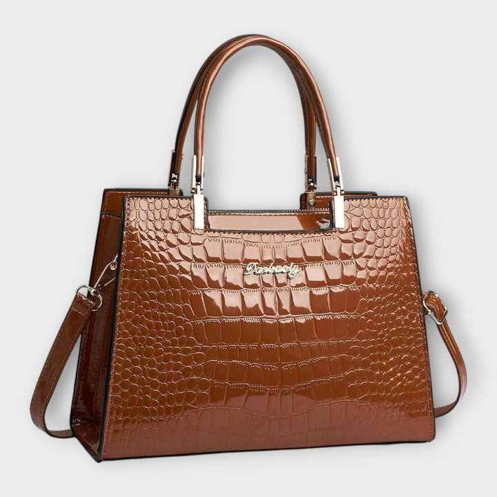 Emilie | Borsa a mano in pelle di coccodrillo lucida" can be rewritten as:

"Emilie | Borsa a mano in pelle lucida effetto coccodrillo