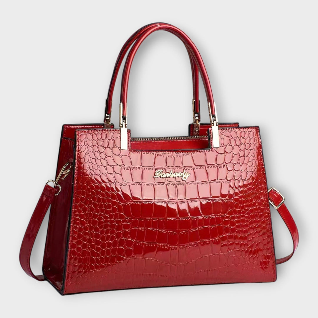 Emilie | Borsa a mano in pelle di coccodrillo lucida" can be rewritten as:

"Emilie | Borsa a mano in pelle lucida effetto coccodrillo
