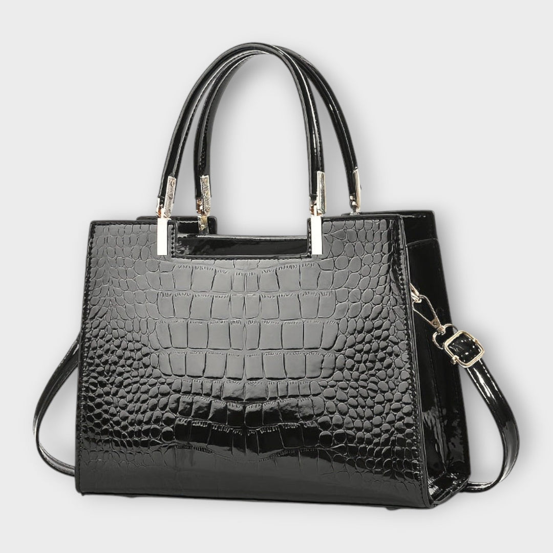 Emilie | Borsa a mano in pelle di coccodrillo lucida" can be rewritten as:

"Emilie | Borsa a mano in pelle lucida effetto coccodrillo