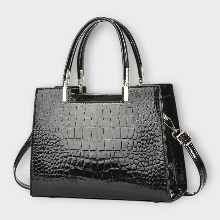 Emilie | Borsa a mano in pelle di coccodrillo lucida" can be rewritten as:

"Emilie | Borsa a mano in pelle lucida effetto coccodrillo